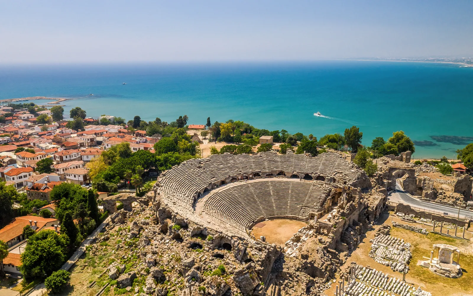 The Roman amphitheatre at Side seen from above, with the town and sea behind