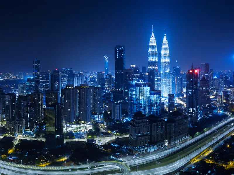 Kuala Lumpur at night, lit towers above the highways