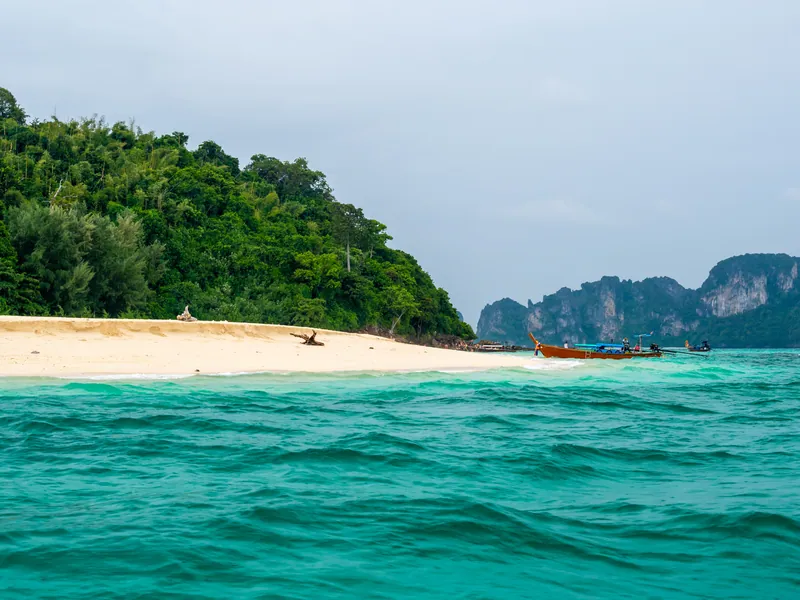 The white sand spit and shallow turquoise water of Bamboo Island