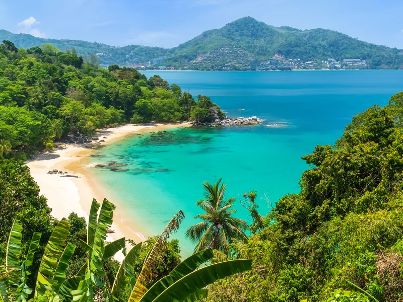 A small palm-backed cove with clear shallow water on Phuket